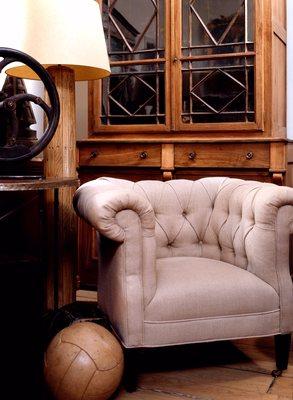 Lee Stanton Editions, Reproduction, A tufted chair with tapered legs upholstered in Belgium linen