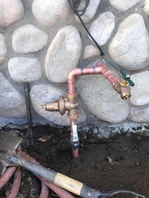 Pressure regulator, water shut off valve and hose Bibb installation.