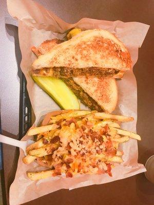 Steak and cheese sandwich with bacon and cheese fries