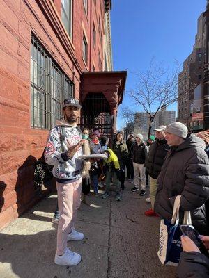 Asad speaking in front of the former home of writer, activist, and songwriter James Weldon Johnson, who wrote "Lift Every Voice and Sing."