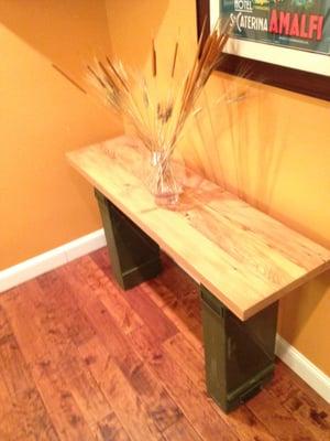 Entry table using reclaimed wood and metal ammunition boxes.