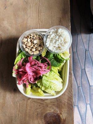 Little gem salad with pickled onions, toasted peanuts, cotija cheese, and a pickled carrot juice dressing.