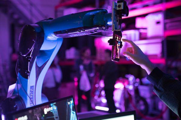 Karl the robotic arm during an event, taking selfies