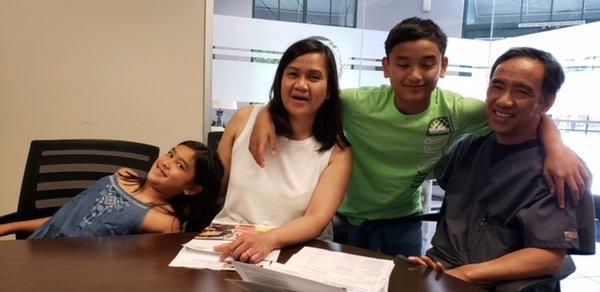 Here's a happy family signing their papers for their home! So exciting!