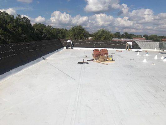 Near completion of flat TPO roof.