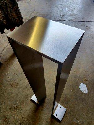 fabricated and finished 1/2" stainless plate.