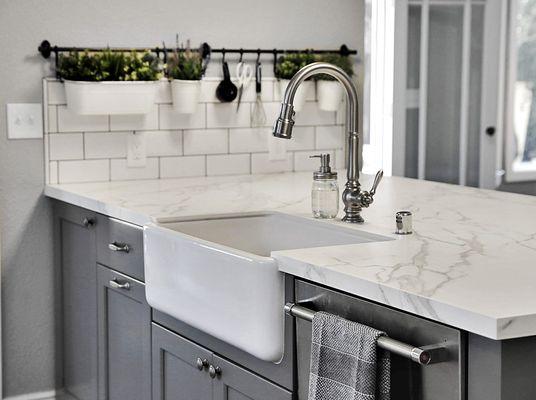 Beautiful Neolith countertops and grey island where wall was before!