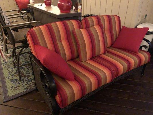 Replacement loveseat cushions in Astoria Sunset with Canvas Jockey Red throw pillows. 
 Sunbrella ® fabric.