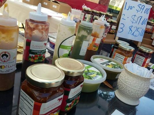 Chutney jars and bowls of salsa as well as taster dispensers at the Hyde Park Sunday Fresh Market