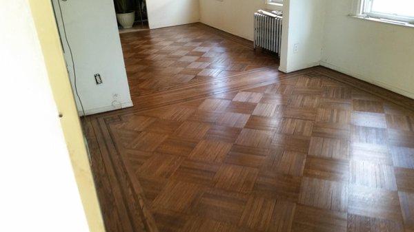 Ripped up carpet to find severely damaged parquet floor. After extensive repair, sanding and staining...