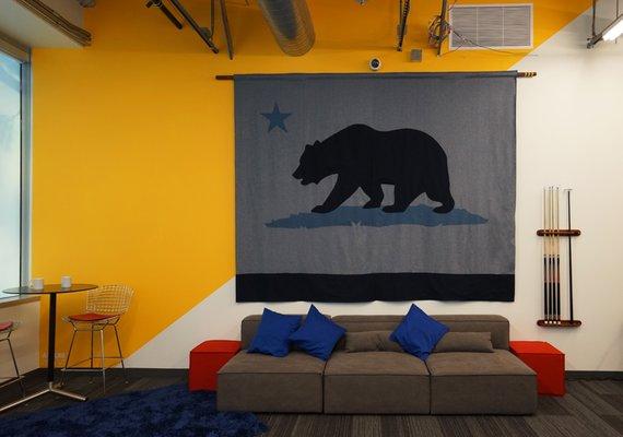 Game room with oversized california flag made from denim.