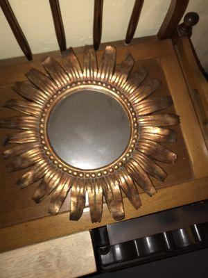 A mirror surround by a gold/ copper color paint, great for any wall or just before u leave your house to check yourself