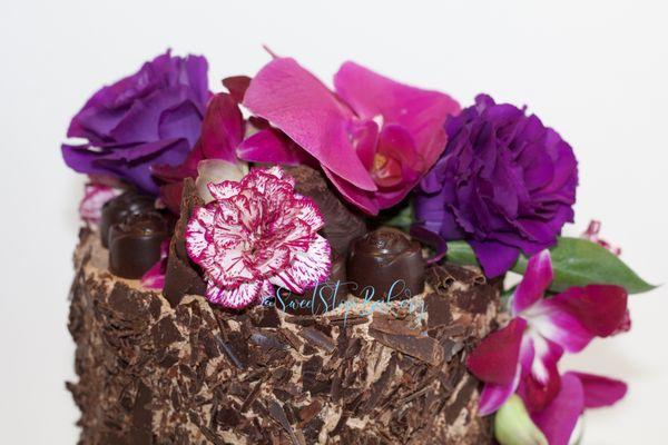 Outstanding Orchids give a burst of color to this Signature Chocolate Cake