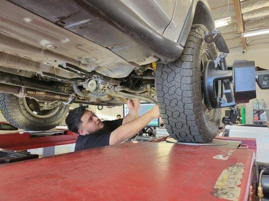 The owner Jose adjusting the caster on my lifted crv. Honda and other companies said it couldn't be done.