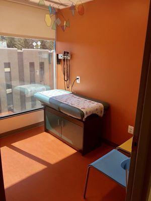 One of the exam rooms, colorful and filled with sunlight.