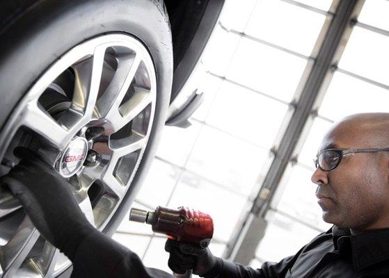 service dept replacing a tire