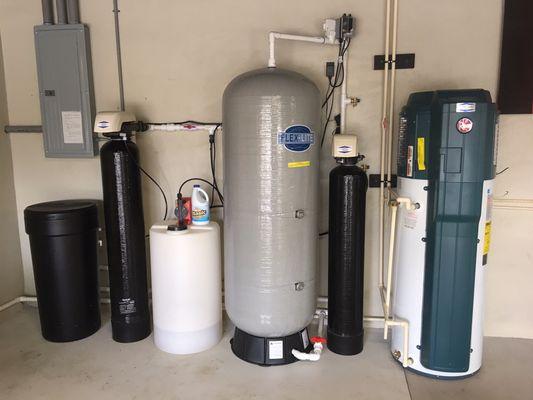 Whole house water softener and chlorination system along with Hybrid electric water heater installed in garage.