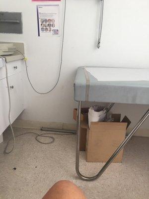 Open boxes, and dirty floor inside exam room