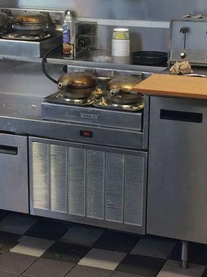 Dirty waffle iron and tissue laying crumbled on the counter.