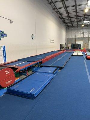 We have one large tumble track, one large rod floor, and also one smaller tumble track for our athletes to use during instruction.