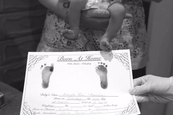 Baby's newborn feet with her proud Born at Home certificate :)