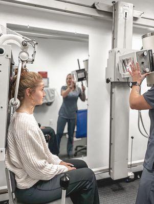 nurses using the x-ray machine with a patient