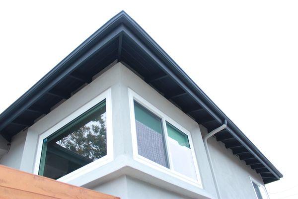 Exterior stucco, concrete, and painting of wall and trim.