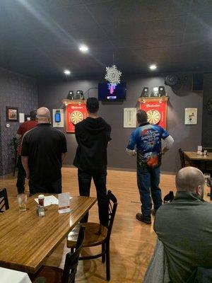 Guys playing darts