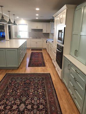 The long view of the kitchen and its many work tops.