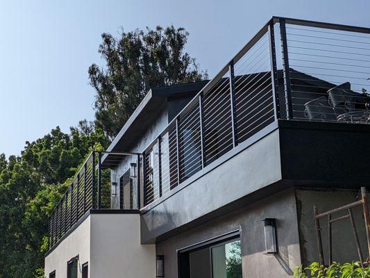 Finished main upper deck and with new stucco finish and metal railing in Malibu.