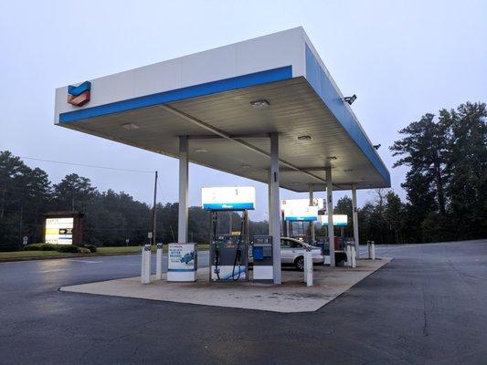 The gas station. It's in front of a strip mall. Six pumps.