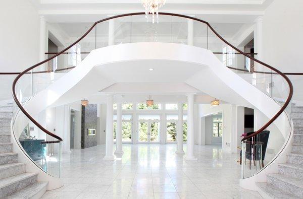 Love this grand entrance with a sweeping marble and glass staircase!  Lasley Brahaney Architecture + Construction...