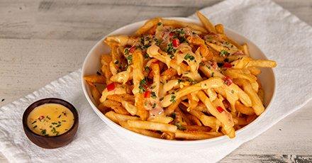 Golden fries topped with rich, creamy queso.