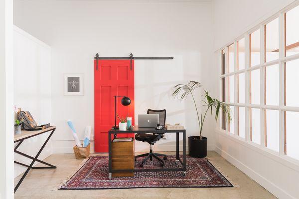 Slide to the left for privacy-slide to the right to escape the work zone at home! A sliding barn door in red is the perfect splash of color