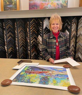 Diane designing the perfect framing to show off a vacation memory.