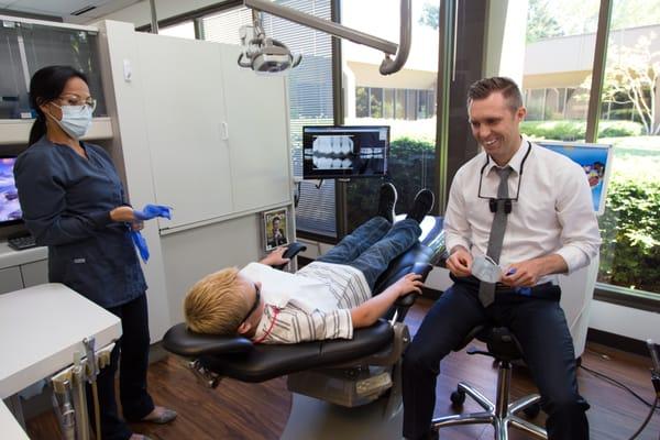 Dr. Ballard loves children.  He has five of his own! Here he is getting smiles out of a nine year old patient.