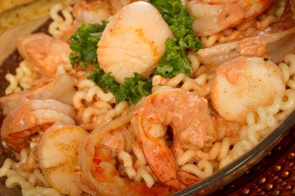 Shrimp and Scallops over Pasta with garlic, fresh herbs in a Parma Rosa Sauce