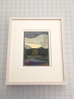 A small oil painting framed in a white washed maple frame.