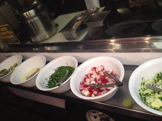 Lemon, onion, cilantro, radishes, and cucumber. 3 salsas: roja, verde, and guac.