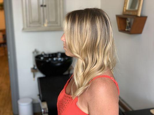 Balayage blonde with roots.