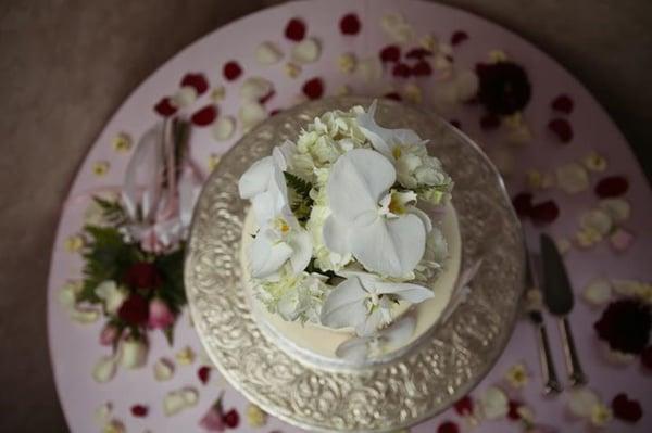 The cake topper, ribbons, and sprinkled flower petals adorning our cake were tasteful and exquisite.