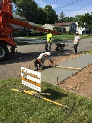 Driveway apron being poured using 4500 lb. concrete at 6" depth as required by code