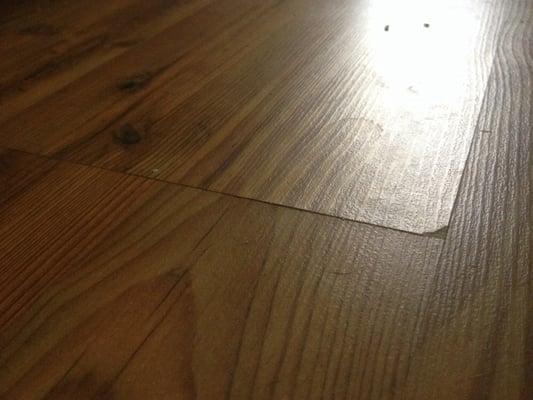 Worker's damaged Laminate floor. Let water drip n sit then chipped when worker's rolled large equipment over it.