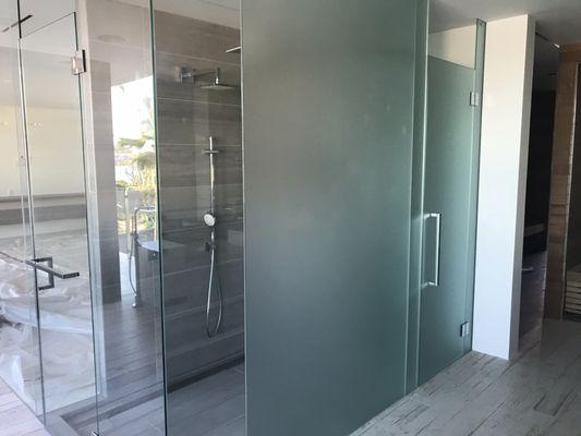 Shower enclosure using both clear float and acid etched glass