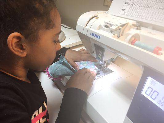 Ella one of our new preteens that is 8 years old. She is making a Flip Flop pillow. Learning to use a sewing machine.