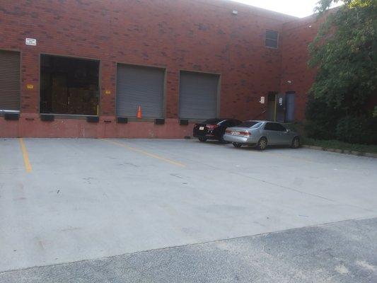 Cars parked in the dock area. Signs say no parking.