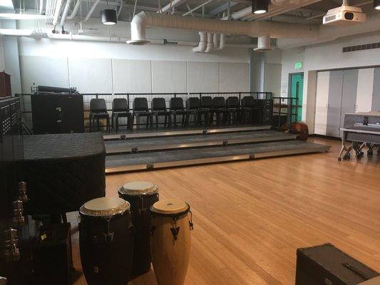 Some classrooms are equipped with pianos and risers for choirs and bands.