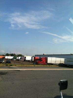 Rusty gates and parked trailers create a tranquil atmosphere.