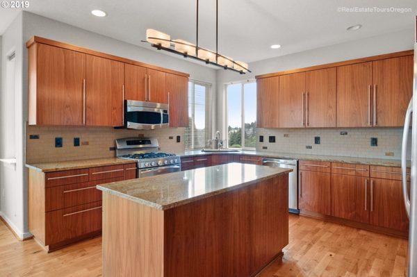 Soft-close drawers, stainless steel appliances with gas range, granite countertops and built-in wine rack and cooler.