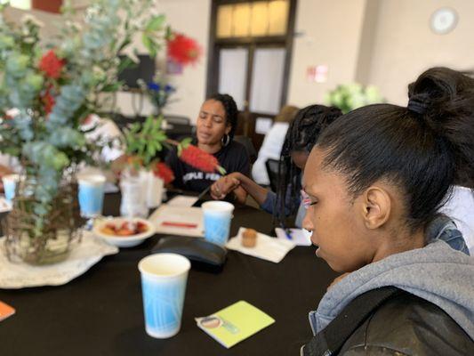 Young adults praying at Prayer Breakfast